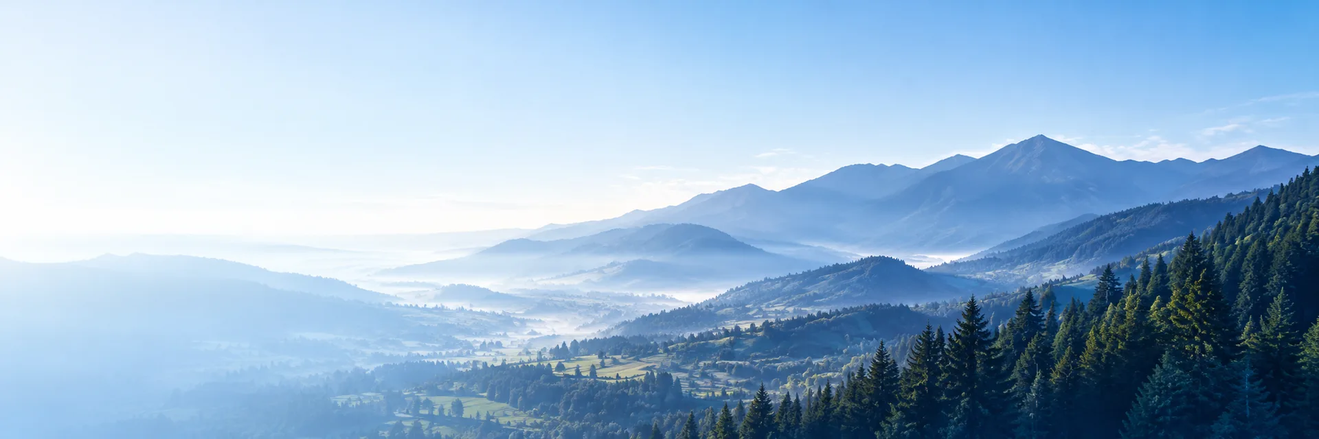 Paisaje de montañas entre la niebla al amanecer.